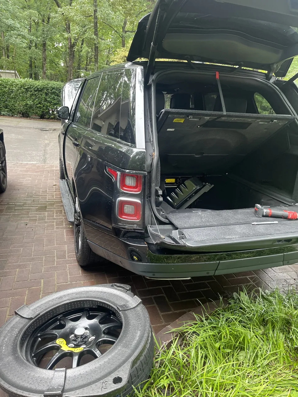 Range Rover prepared for mobile tire service with the spare wheel ready